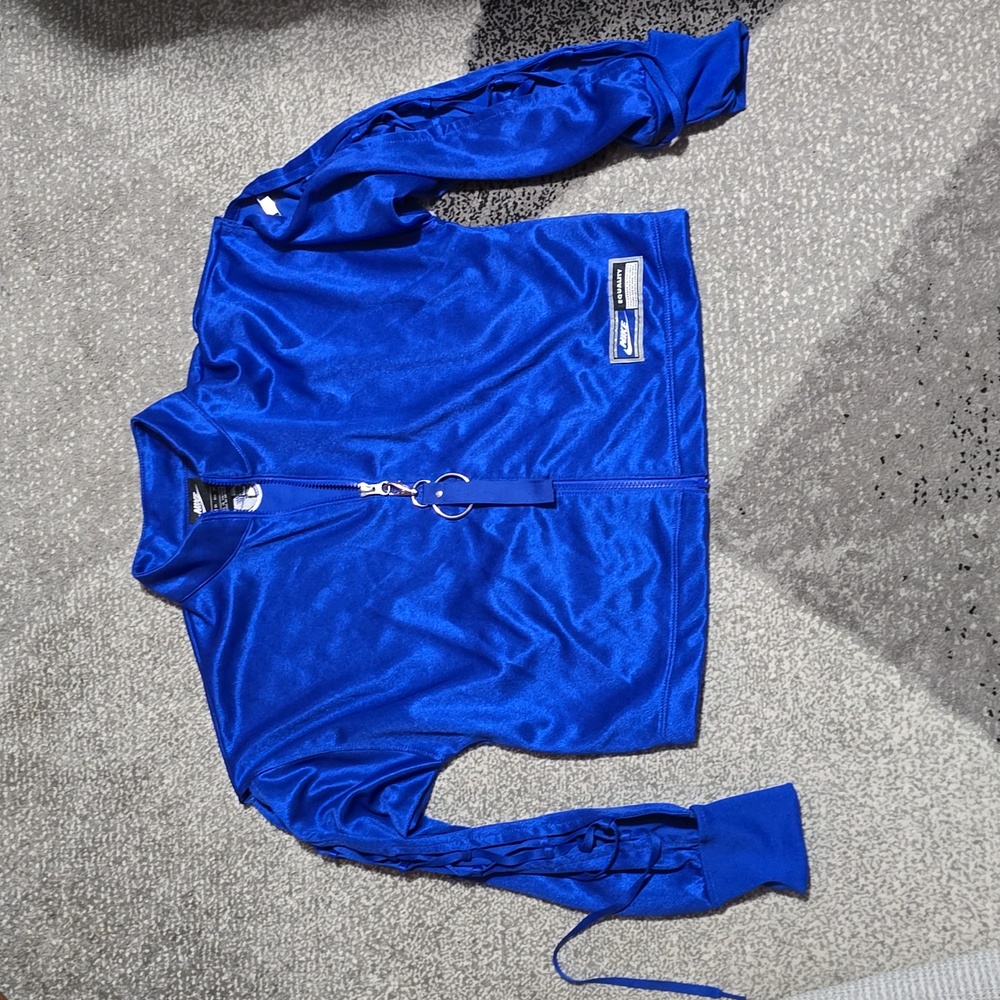Nike cropped track jacket with lace-up sleeves.